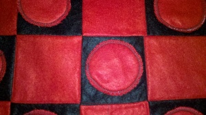 Top stitched around the outside of the checker so you could SEE it!! Helps it to stand out.